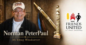 Norman PeterPaul with two of his wood carvings in a Friends United social image