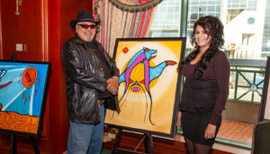 Mi'kmaq artist David J. Brooks and Chelsea Brooks beside one of David J. Brooks' artworks at the Friends United Halifax Exhibition 2013 at Casino Nova Scotia in Halifax, Nova Scotia.