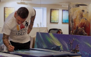 Jasyn Lucas painting during the Friends United Artist in Residence Program