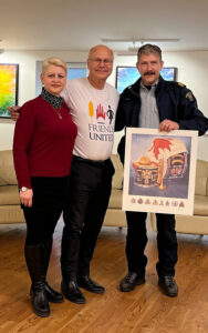 RCMP representative presenting an art print to Friends United representatives